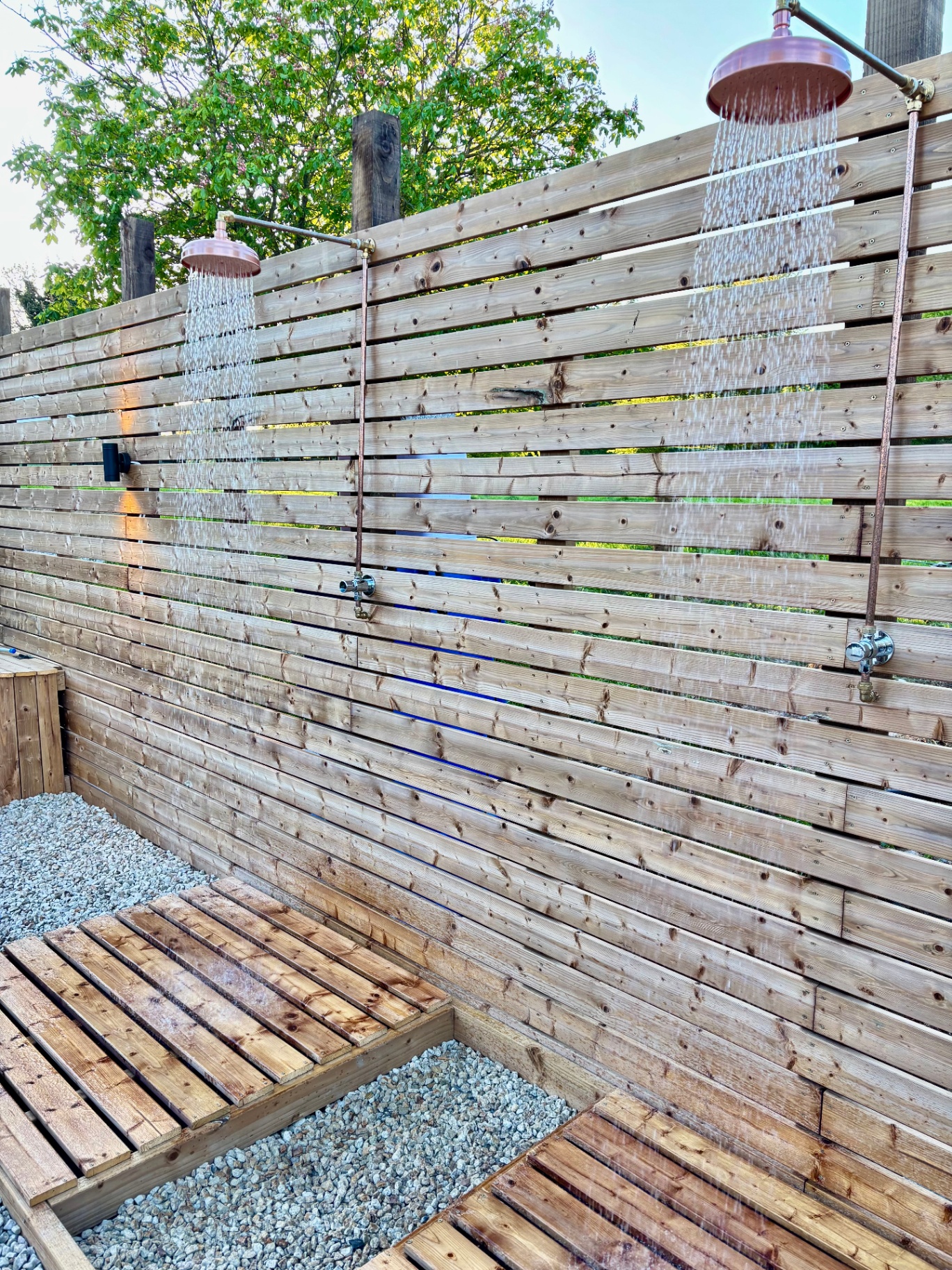 Outdoor copper rain showers on cedar deck